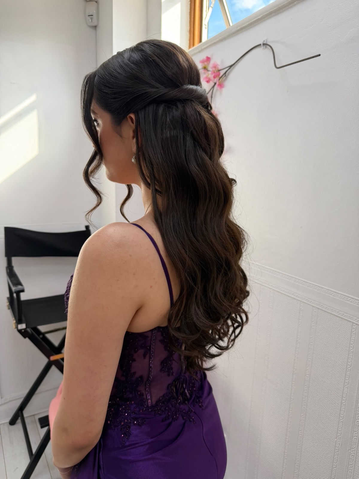 Half-up bridal hair with long barrel-curled waves, seen from behind