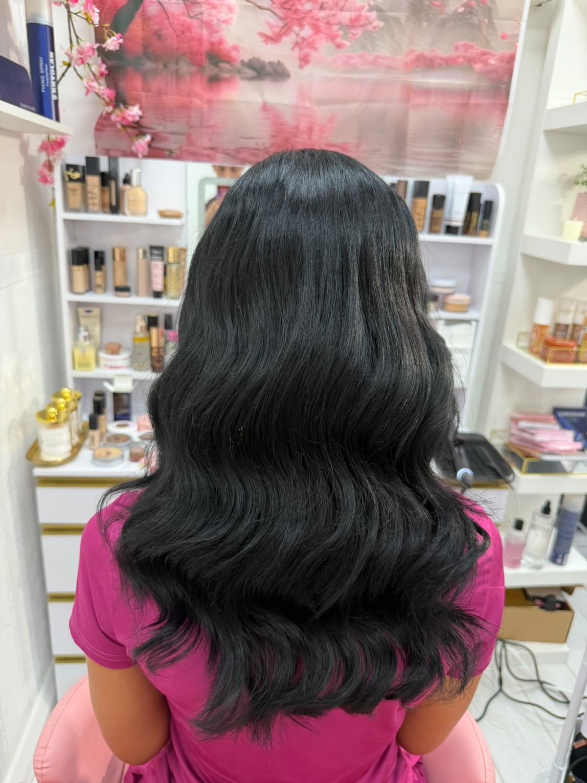 Glossy jet-black blow-dry with deep bouncy waves