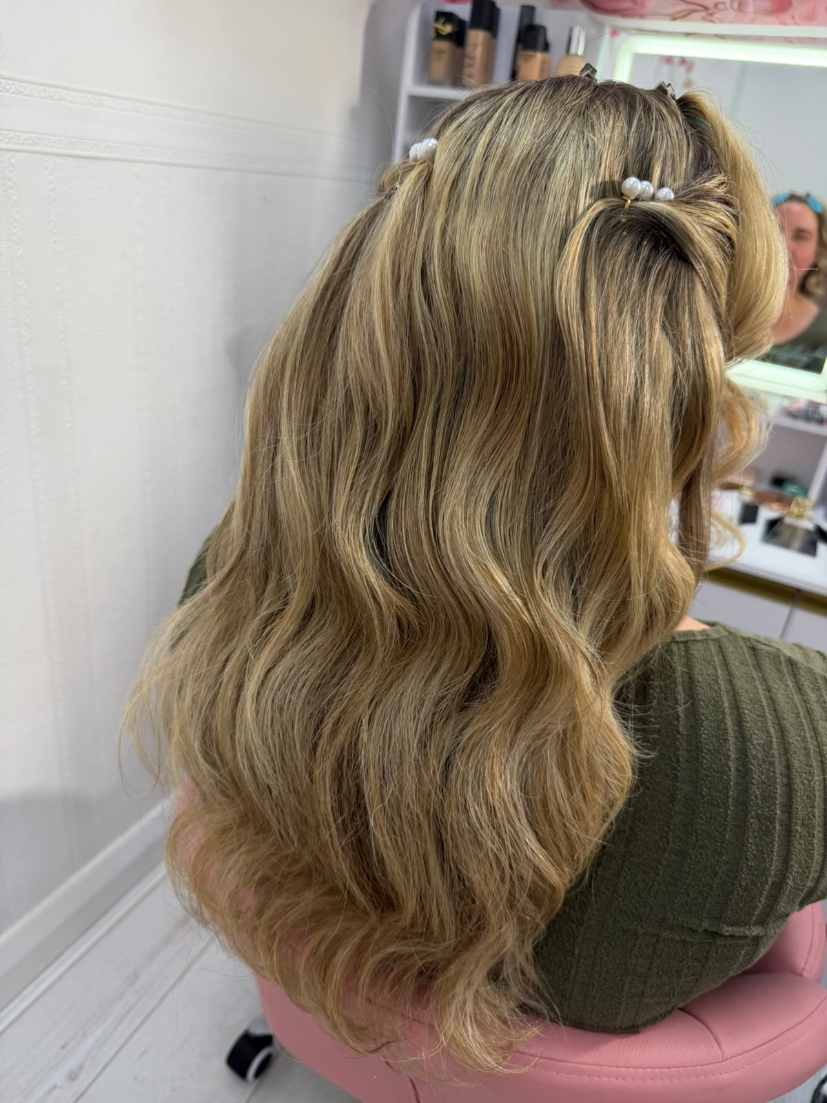 Blonde half-up style with pearl pins and soft waves