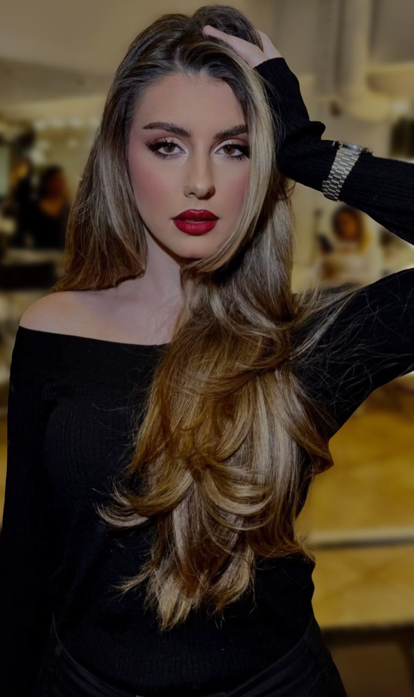 Long layered honey-blonde hair with a bold red lip