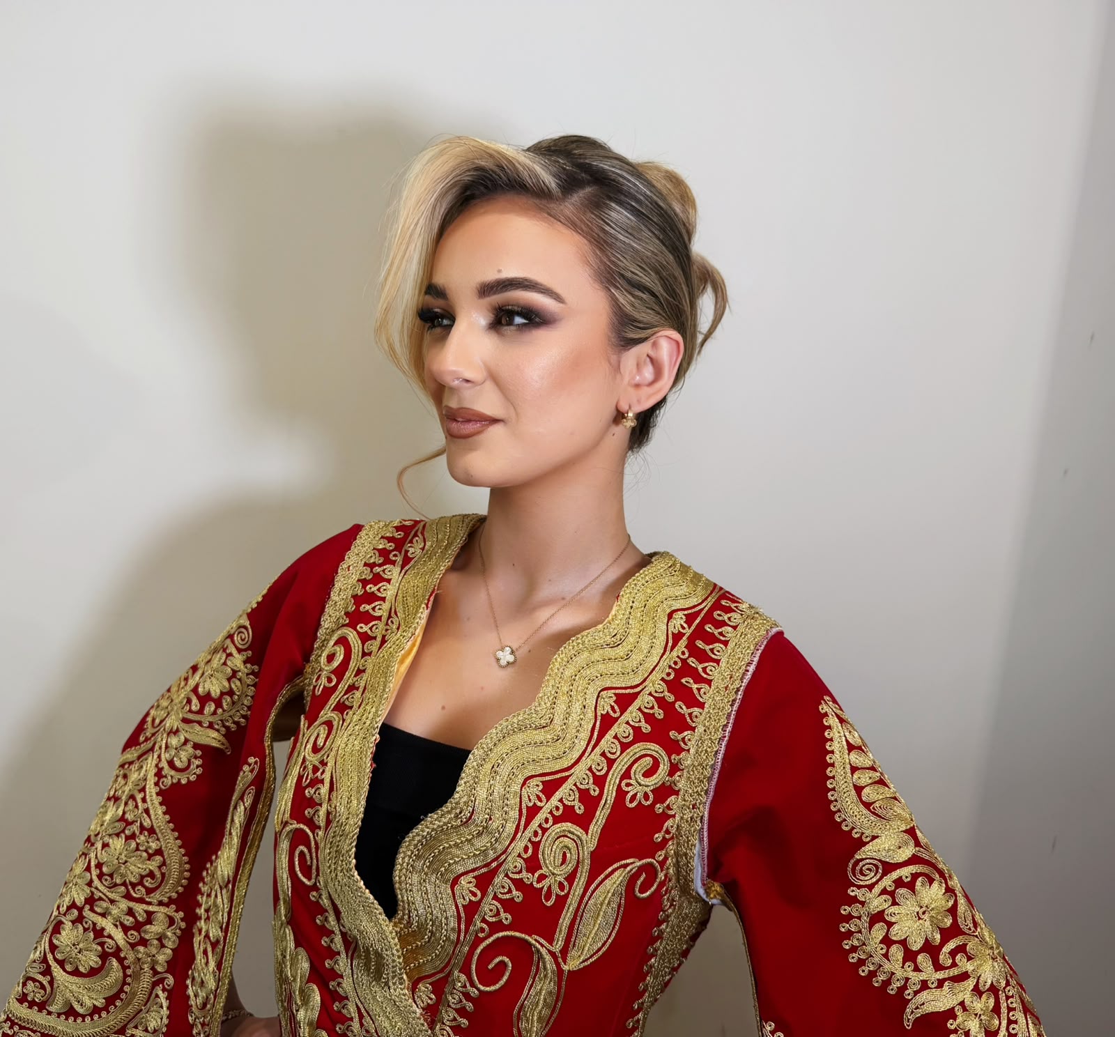 Traditional red and gold dress with a blonde updo and bronzed glam
