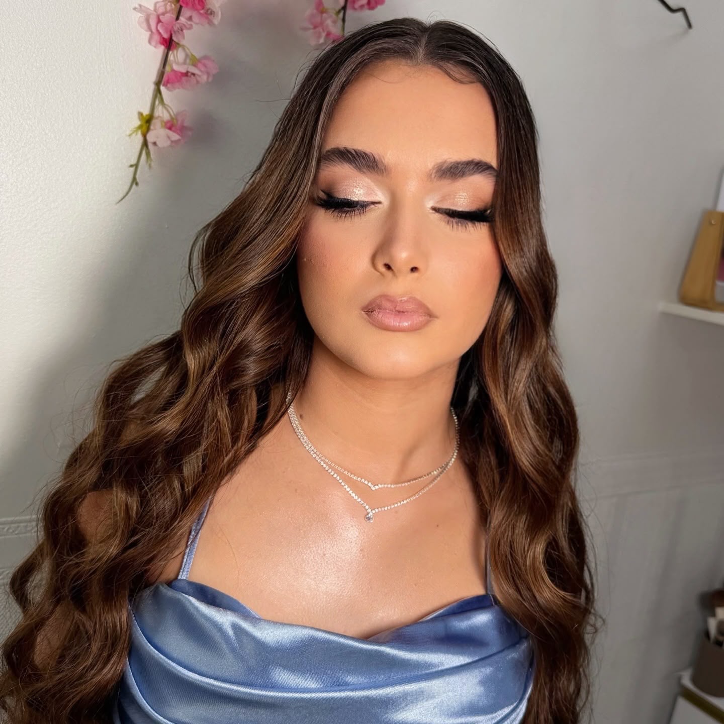 Glowing skin and fluttery lashes with a blue satin gown