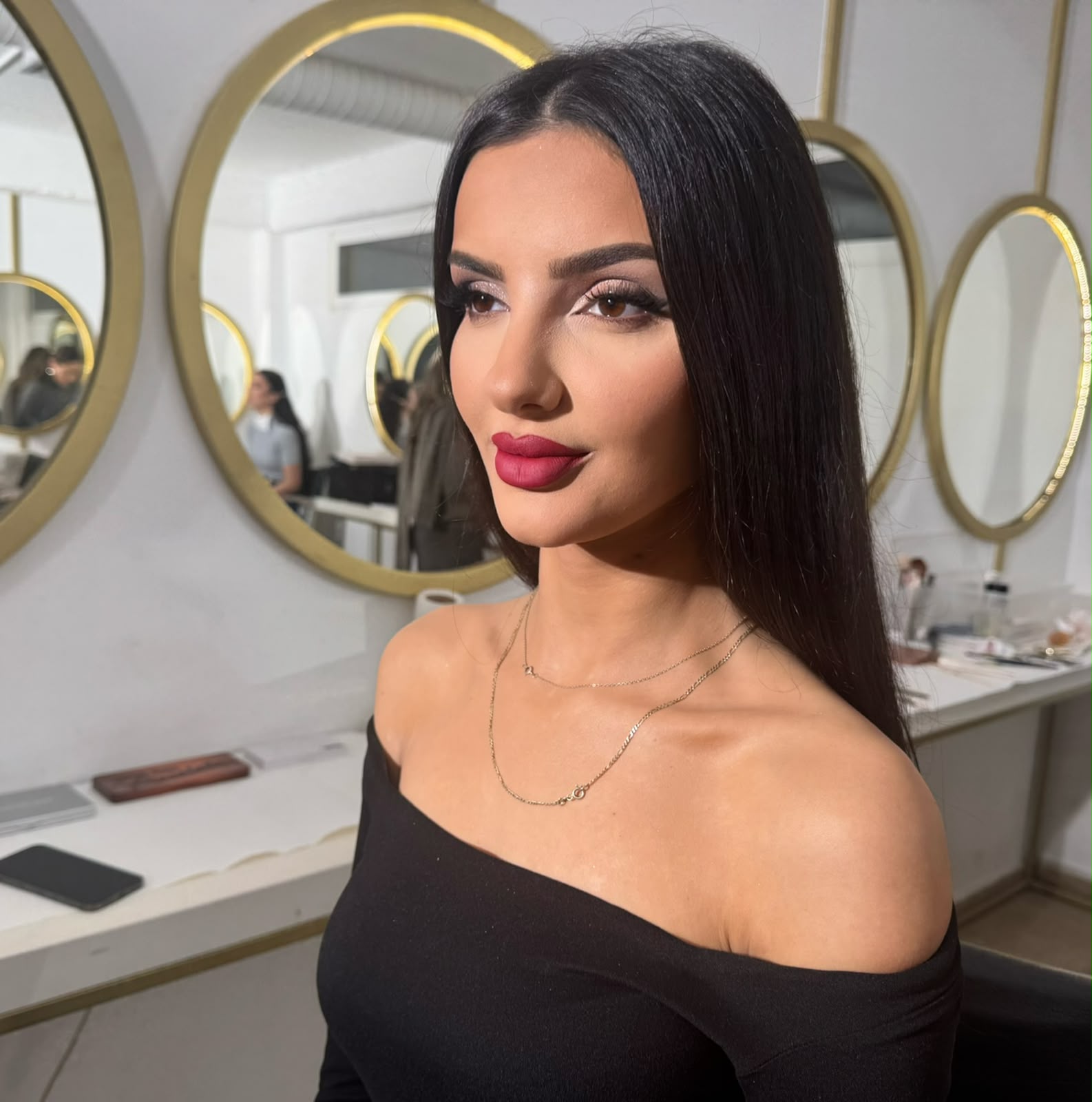 Sleek black hair with a deep berry lip in the studio