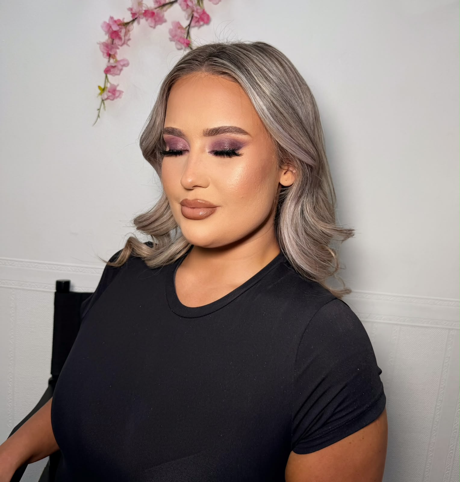 Icy blonde waves with a purple smokey eye