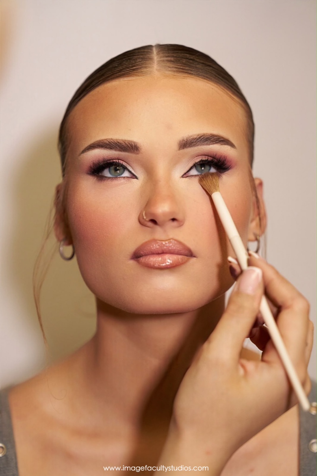 Behind the scenes — softening liner under the eye with a brush