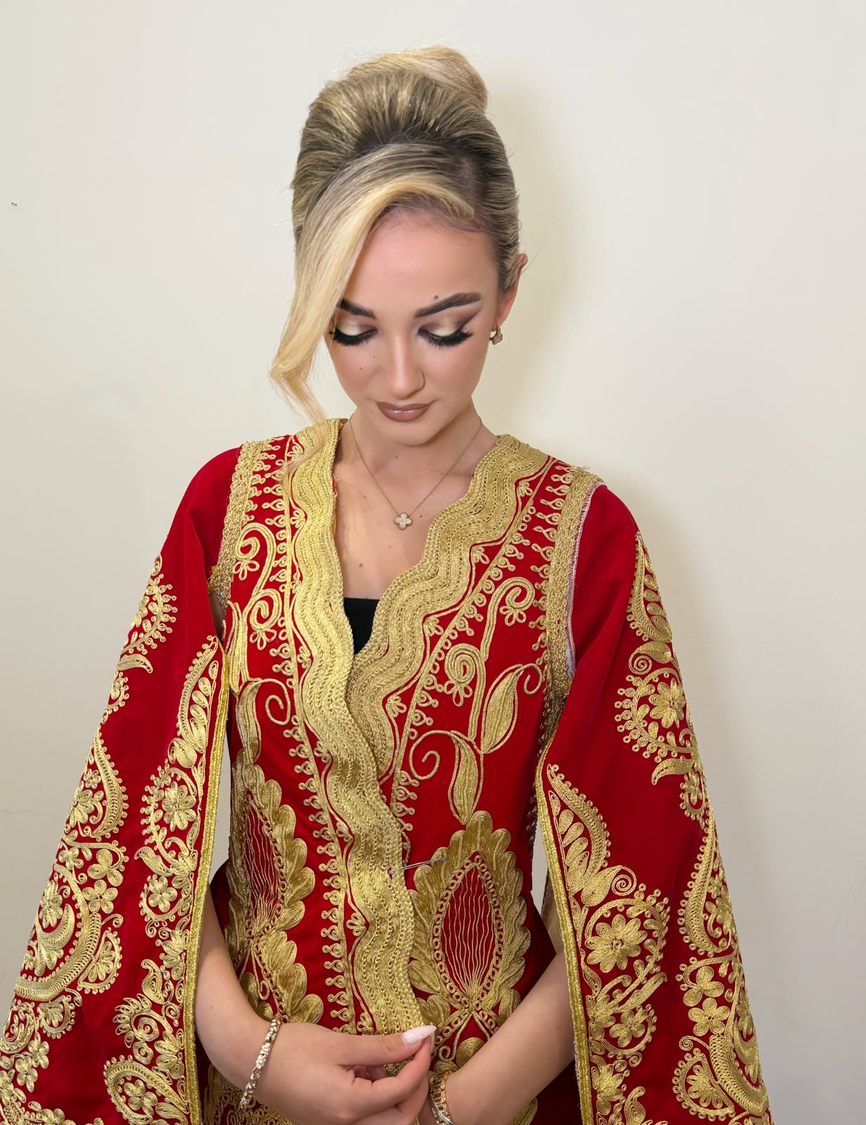 Traditional red and gold dress with a high blonde updo