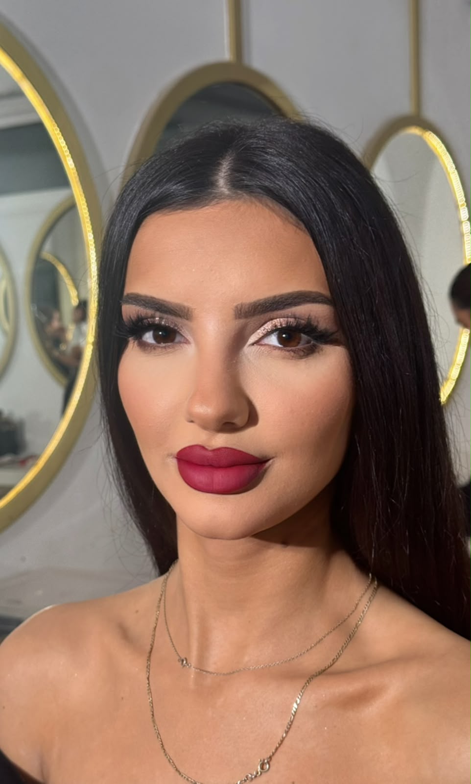 Close-up glam with a deep berry lip and sleek black hair